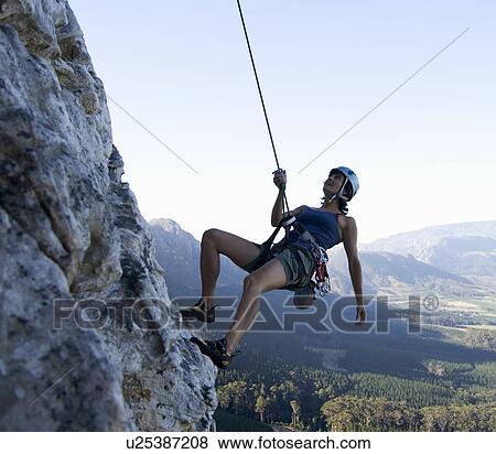 Stock Photo - A climber abseiling. Fotosearch