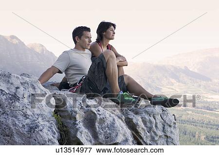 Two climbers resting at the top View Large Photo Image Stock Photo - Two climbers resting at the top. Fotosearch