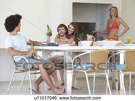 Stock Photograph - A group of teenage friends at a barbeque. Fotosearch