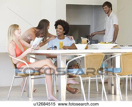 Stock Photography - A group of teenage friends at a barbeque. Fotosearch