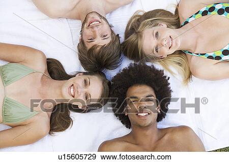 A group of teenage friends sunbathing View Large Photo Image Stock Photo - A group of teenage friends sunbathing. Fotosearch