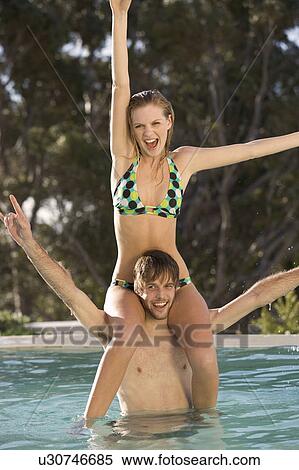A teenage couple having fun in a swimming pool View Large Photo Image Stock Photography - A teenage couple having fun in a swimming pool. Fotosearch