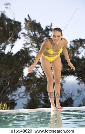 A teenage girl having fun by a swimming pool View Large Photo Image Stock Image - A teenage girl having fun by a swimming pool. Fotosearch