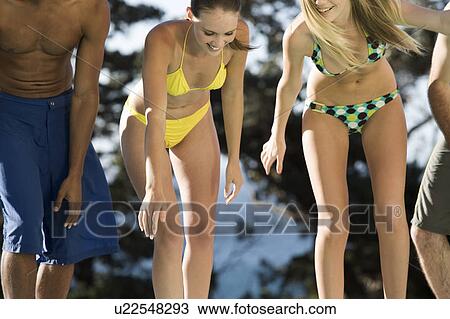Four teenage friends having fun in a swimming pool View Large Photo Image Stock Image - Four teenage friends having fun in a swimming pool. Fotosearch