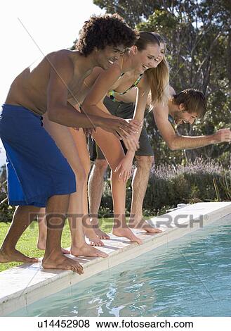 Stock Photo - Four teenage friends having fun in a swimming pool. Fotosearch