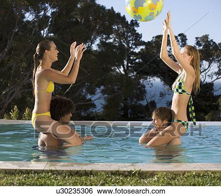 Four teenage friends having fun in a swimming pool View Large Photo Image Stock Photograph - Four teenage friends having fun in a swimming pool. Fotosearch
