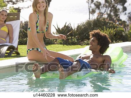 Stock Photo - Three teenage friends by the pool. Fotosearch