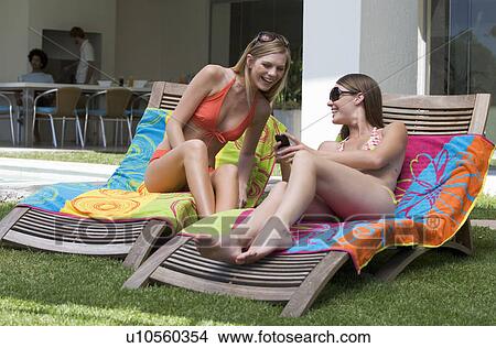 Picture - Two teenage girls sunbathing. Fotosearch