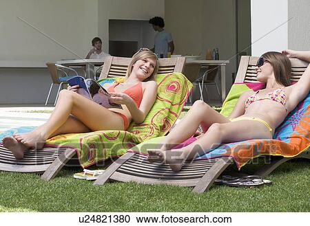 Two teenage girls sunbathing View Large Photo Image Stock Image - Two teenage girls sunbathing. Fotosearch