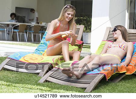 Two teenage girls sunbathing View Large Photo Image Stock Photo - Two teenage girls sunbathing. Fotosearch