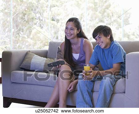 A brother and sister watching TV View Large Photo Image Stock Image - A brother and sister watching TV. Fotosearch