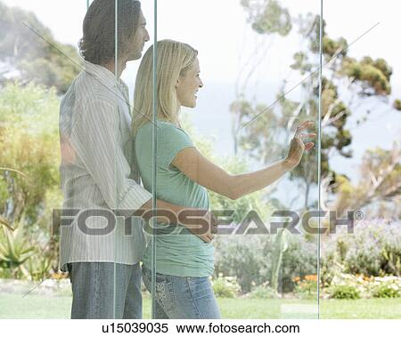 Stock Photography - A couple looking at their garden. Fotosearch