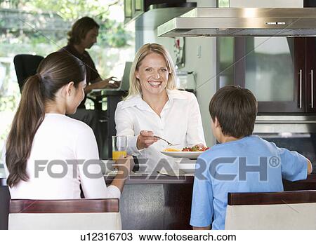 Stock Image - A family eating breakfast. Fotosearch
