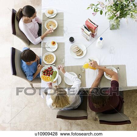 A family eating breakfast View Large Photo Image Stock Photo - A family eating breakfast. Fotosearch