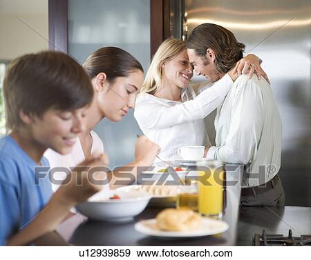 Stock Photo - A family eating breakfast. Fotosearch