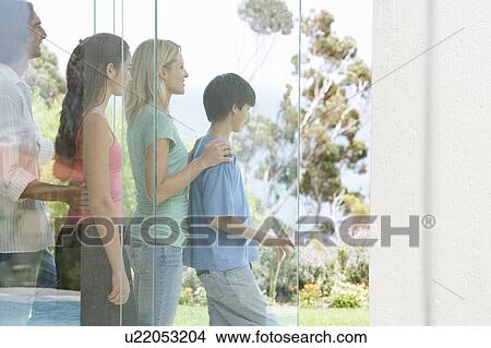 A family looking at their garden View Large Photo Image Picture - A family looking at their garden. Fotosearch