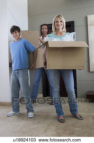 Stock Image - A family moving into a new home. Fotosearch