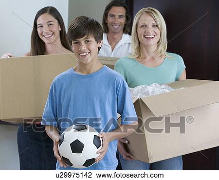 Stock Image - A family moving into a new home. Fotosearch