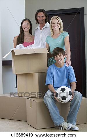 A family moving into a new home View Large Photo Image Stock Photo - A family moving into a new home. Fotosearch