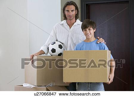 Stock Photo - A father and son moving into a new home. Fotosearch