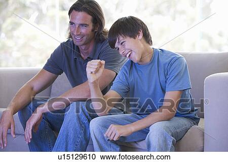 A father and son watching TV View Large Photo Image Stock Image - A father and son watching TV. Fotosearch