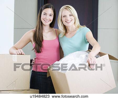 Stock Image - A mother and daughter moving into a new home. Fotosearch