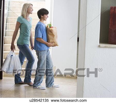 A mother and son coming home with the shopping View Large Photo Image Stock Photography - A mother and son coming home with the shopping. Fotosearch
