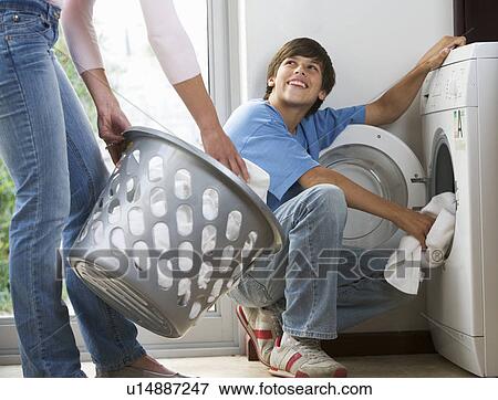A mother and son loading the washing machine View Large Photo Image Stock Photo - A mother and son loading the washing machine. Fotosearch