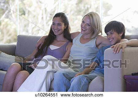 Stock Image - A mother watching TV with her children. Fotosearch