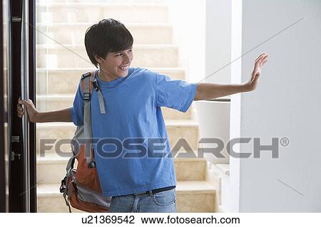 Stock Image - A young boy leaving for school. Fotosearch