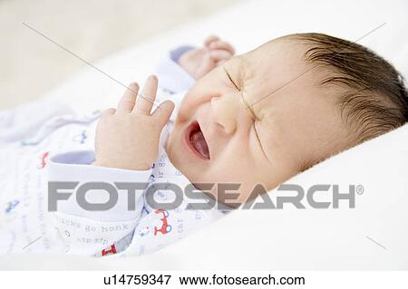 Stock Photo - A baby crying. Fotosearch