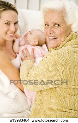 A grandmother greeting her new grandchild after the birth View Large Photo Image Picture - A grandmother greeting her new grandchild after the birth. Fotosearch