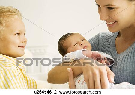 Stock Image - A mother and her son with a new baby. Fotosearch