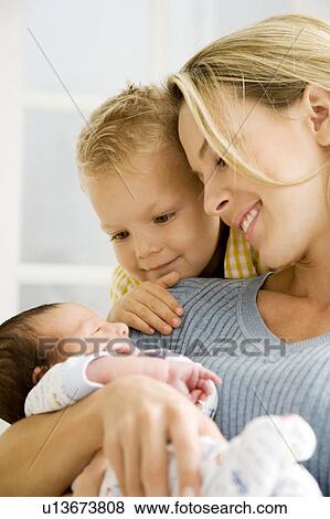 A mother and her son with a new baby View Large Photo Image Stock Photo - A mother and her son with a new baby. Fotosearch