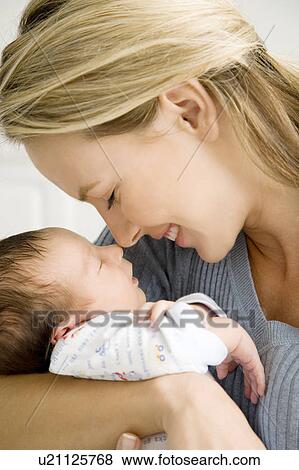 Stock Photo - Mother holding her young baby. Fotosearch