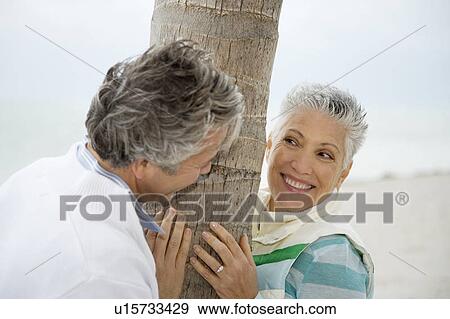 Stock Photo - A senior couple on a beach. Fotosearch