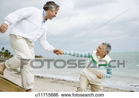 A senior couple on a beach View Large Photo Image Stock Photograph - A senior couple on a beach. Fotosearch