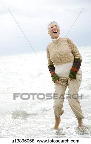 A senior woman on a beach View Large Photo Image Stock Photo - A senior woman on a beach. Fotosearch