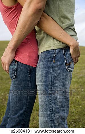 Stock Image - Two young lovers embracing. Fotosearch