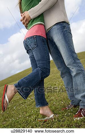 Two young lovers embracing View Large Photo Image Stock Image - Two young lovers embracing. Fotosearch