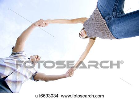 Two young lovers holding hands View Large Photo Image Picture - Two young lovers holding hands. Fotosearch