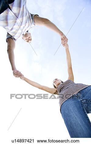 Two young lovers holding hands View Large Photo Image Stock Image - Two young lovers holding hands. Fotosearch