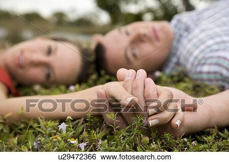 Stock Photograph - Two young lovers holding hands. Fotosearch