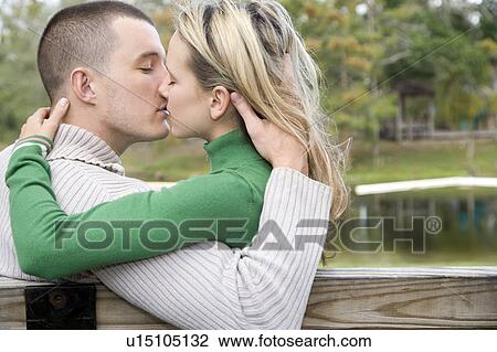 Stock Image - Two young lovers kissing. Fotosearch