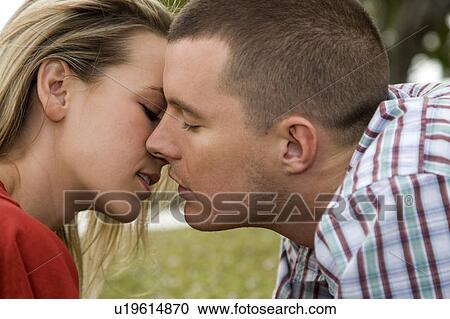 Stock Image - Two young lovers kissing. Fotosearch