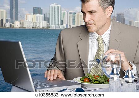A businessman having lunch View Large Photo Image Stock Image - A businessman having lunch. Fotosearch