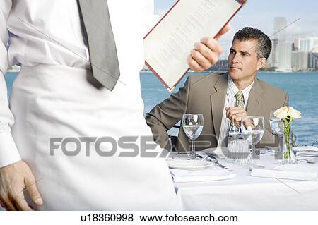 Stock Photo - A businessman having lunch. Fotosearch