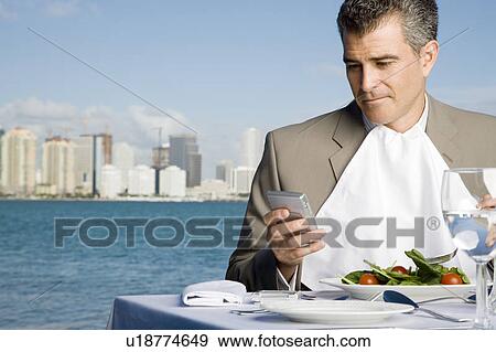 Stock Photo - A businessman having lunch. Fotosearch