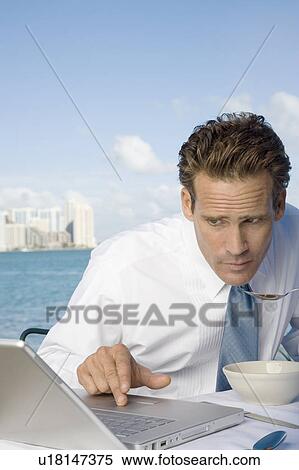 Stock Photography - A businessman having lunch. Fotosearch