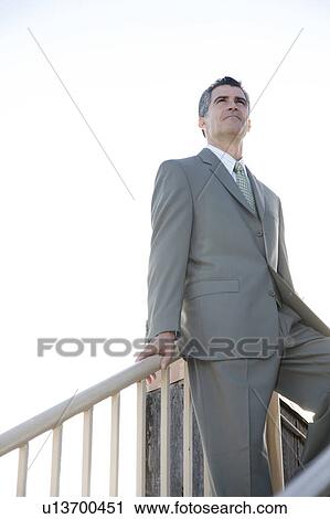 A businessman standing on the top of a flight of steps View Large Photo Image Stock Image - A businessman standing on the top of a flight of steps. Fotosearch